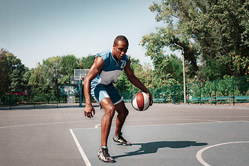 Image showing Picture of young confused african basketball player practicing