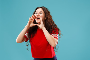 Image showing Isolated on pink young casual woman shouting at studio