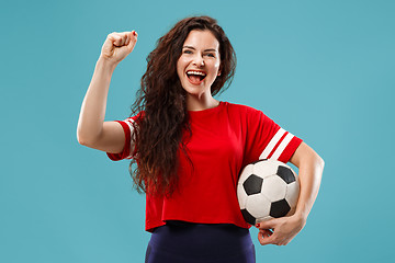 Image showing Fan sport woman player holding soccer ball isolated on blue background