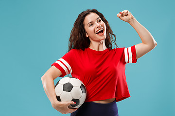 Image showing Fan sport woman player holding soccer ball isolated on blue background