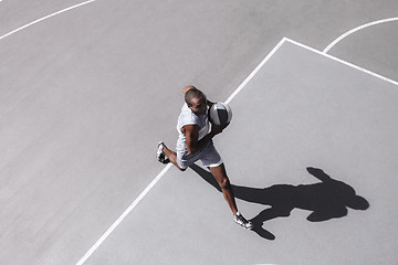 Image showing Picture of young confused african basketball player practicing