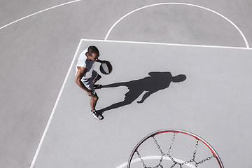 Image showing Picture of young confused african basketball player practicing