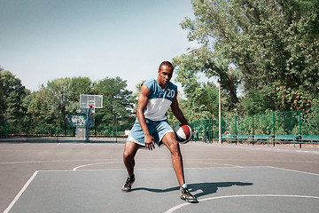 Image showing Picture of young confused african basketball player practicing