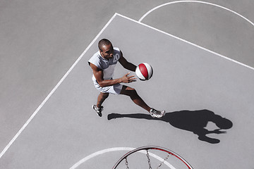 Image showing Picture of young confused african basketball player practicing