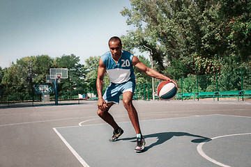 Image showing Picture of young confused african basketball player practicing