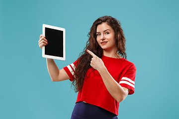 Image showing The happy businesswoman with red laptop on blue