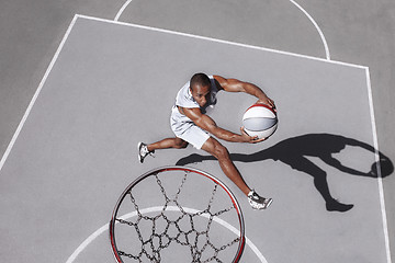 Image showing Picture of young confused african basketball player practicing