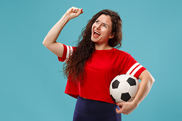 Image showing Fan sport woman player holding soccer ball isolated on blue background