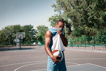 Image showing Picture of young confused african basketball player practicing