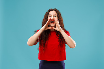 Image showing Isolated on pink young casual woman shouting at studio