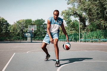 Image showing Picture of young confused african basketball player practicing