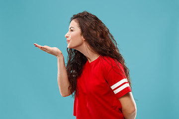 Image showing The happy business woman standing and smiling against blue background.