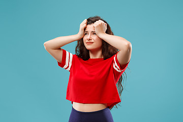 Image showing Beautiful woman in stress isolated on blue