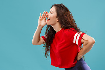 Image showing Isolated on pink young casual woman shouting at studio