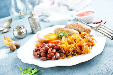 Image showing sausages with fried cabbage