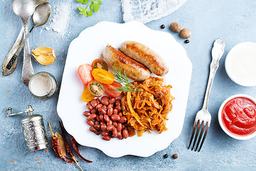 Image showing sausages with fried cabbage