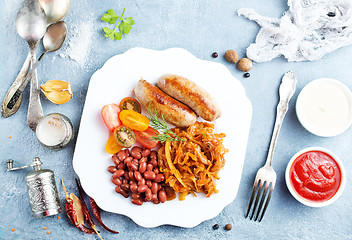 Image showing sausages with fried cabbage