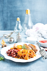 Image showing sausages with fried cabbage