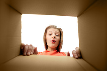 Image showing happy surprised girl looking into gift box