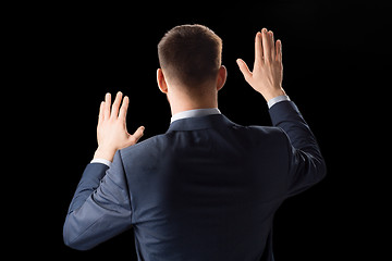 Image showing businessman working with invisible virtual screen