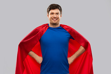Image showing man in red superhero cape over grey background