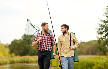 Image showing friends with fishing rods and net at lake or river