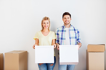 Image showing happy couple with boxes moving to new home