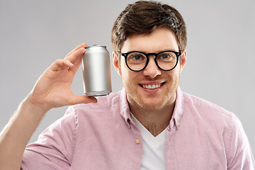 Image showing happy young man holding tin can with soda