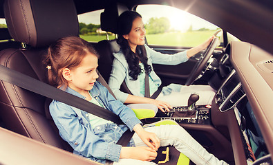 Image showing happy woman with little child driving in car