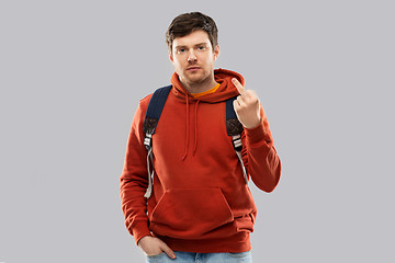 Image showing male student with school bag showing middle finger