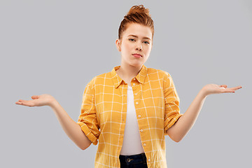 Image showing sad red haired teenage girl shrugging