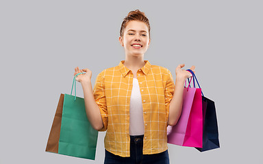 Image showing smiling red haired teenage girl with shopping bags