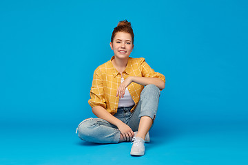 Image showing red haired teenage girl in shirt and torn jeans