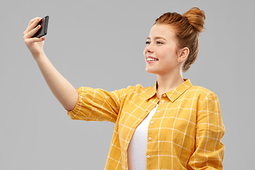 Image showing redhead teenage girl taking selfie by smartphone