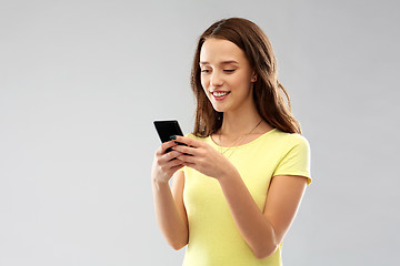 Image showing young woman or teenage girl using smartphone