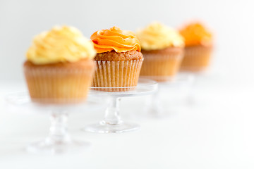 Image showing cupcakes with frosting on confectionery stands