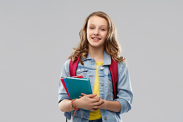 Image showing happy smiling teenage student girl with school bag