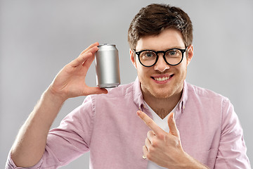 Image showing happy young man holding tin can with soda