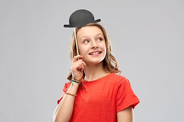 Image showing smiling teenage girl with bowler hat party prop