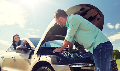 Image showing couple with open hood of broken car at countryside