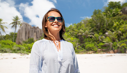 Image showing happy smiling woman in sunglasses over beach