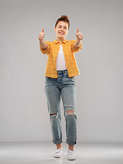 Image showing happy red haired teenage girl showing thumbs up