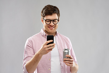 Image showing young man in glasses with smartphone and drink