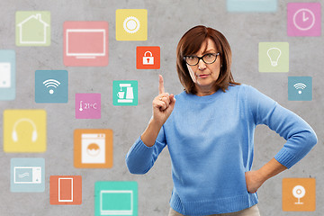 Image showing worried senior woman pointing to lock icon