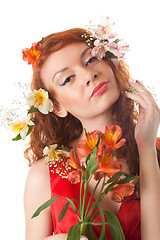 Image showing Portrait of beautiful woman with spring flowers on white