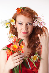 Image showing Portrait of beautiful woman with spring flowers