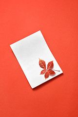 Image showing Congratulation card with fall grape leaf on a coral.