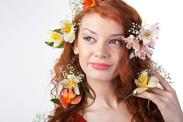 Image showing Portrait of beautiful woman with spring flowers on white