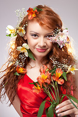 Image showing Portrait of beautiful woman with spring flowers 