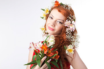 Image showing Portrait of beautiful woman with spring flowers